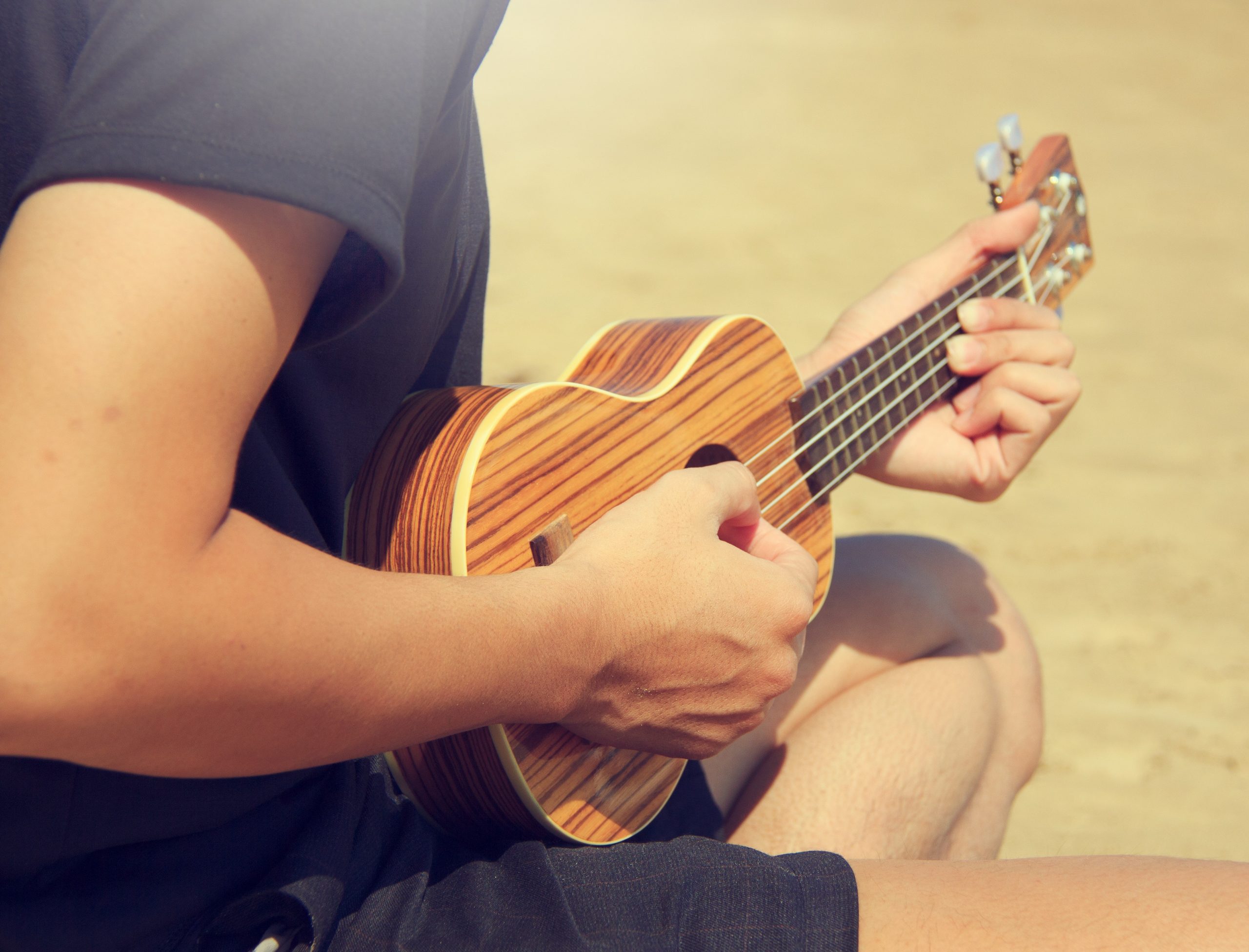 Strumming a ukulele